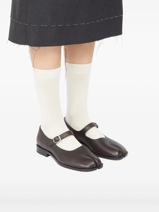 Brown shoes worn by a person, showing the shoes fit