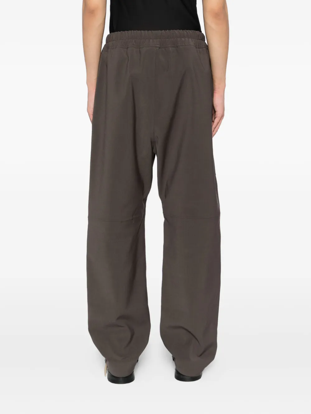 Brown pants worn by a person, showing the pants fit