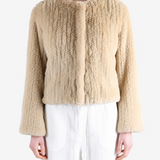 Tan jacket worn by a person, showing the jacket fit