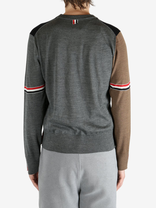 Blue knitwear worn by a person, showing the knitwear fit