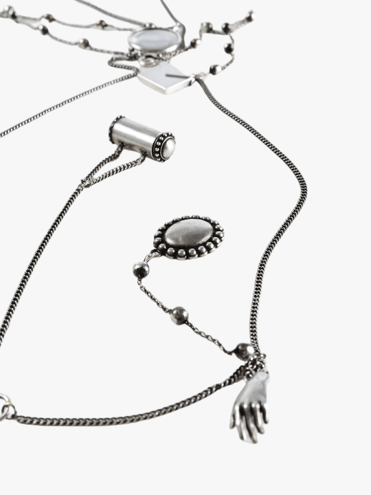 Close up of grey necklace,showing texture of the brass fabric