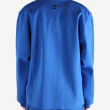Blue sweatshirt worn by a person, showing the shirt's fit