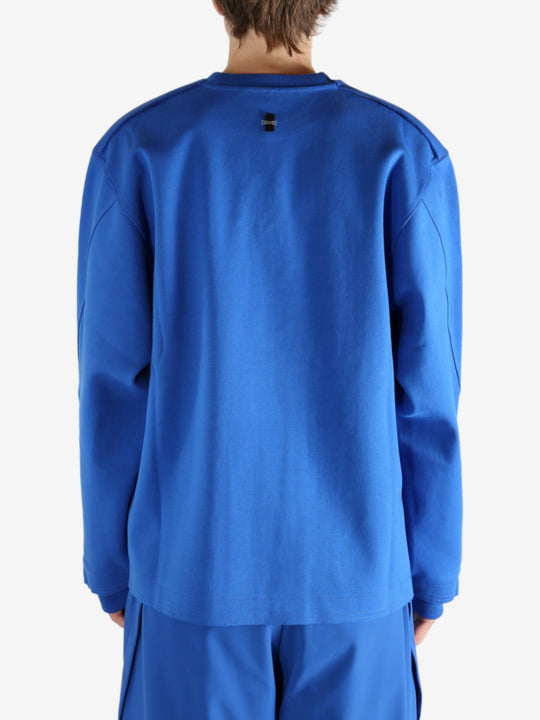 Blue sweatshirt worn by a person, showing the shirt's fit
