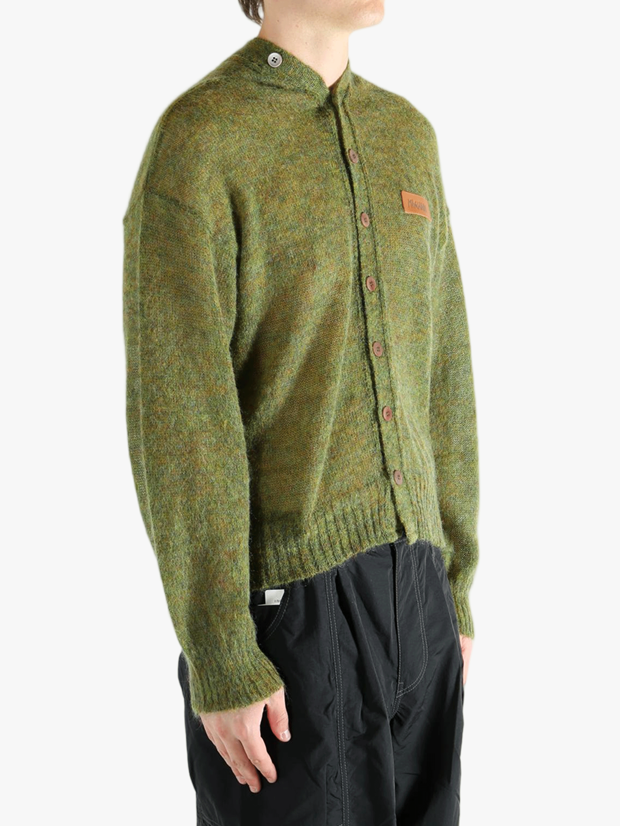 Green cardigan worn by a person, showing the cardigan's fit