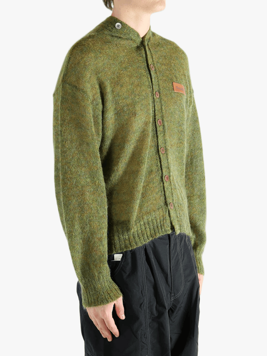 Green cardigan worn by a person, showing the cardigan's fit
