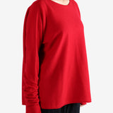 Red knitwear worn by a person, showing the knitwear's fit