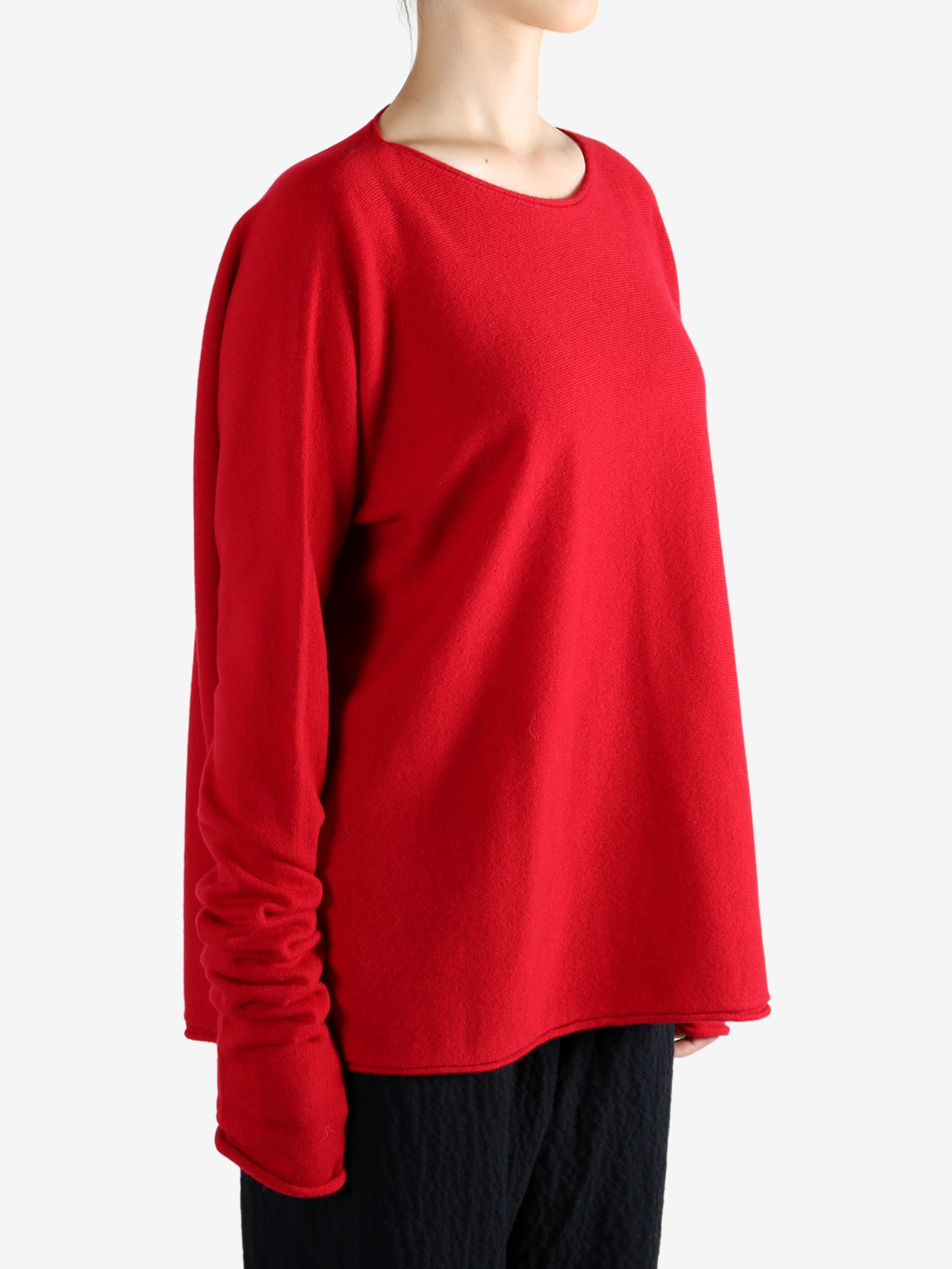 Red knitwear worn by a person, showing the knitwear's fit
