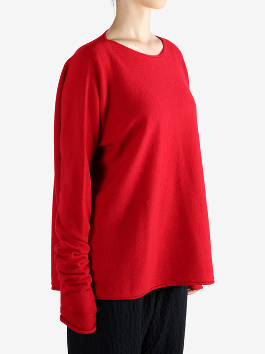 Red knitwear worn by a person, showing the knitwear's fit