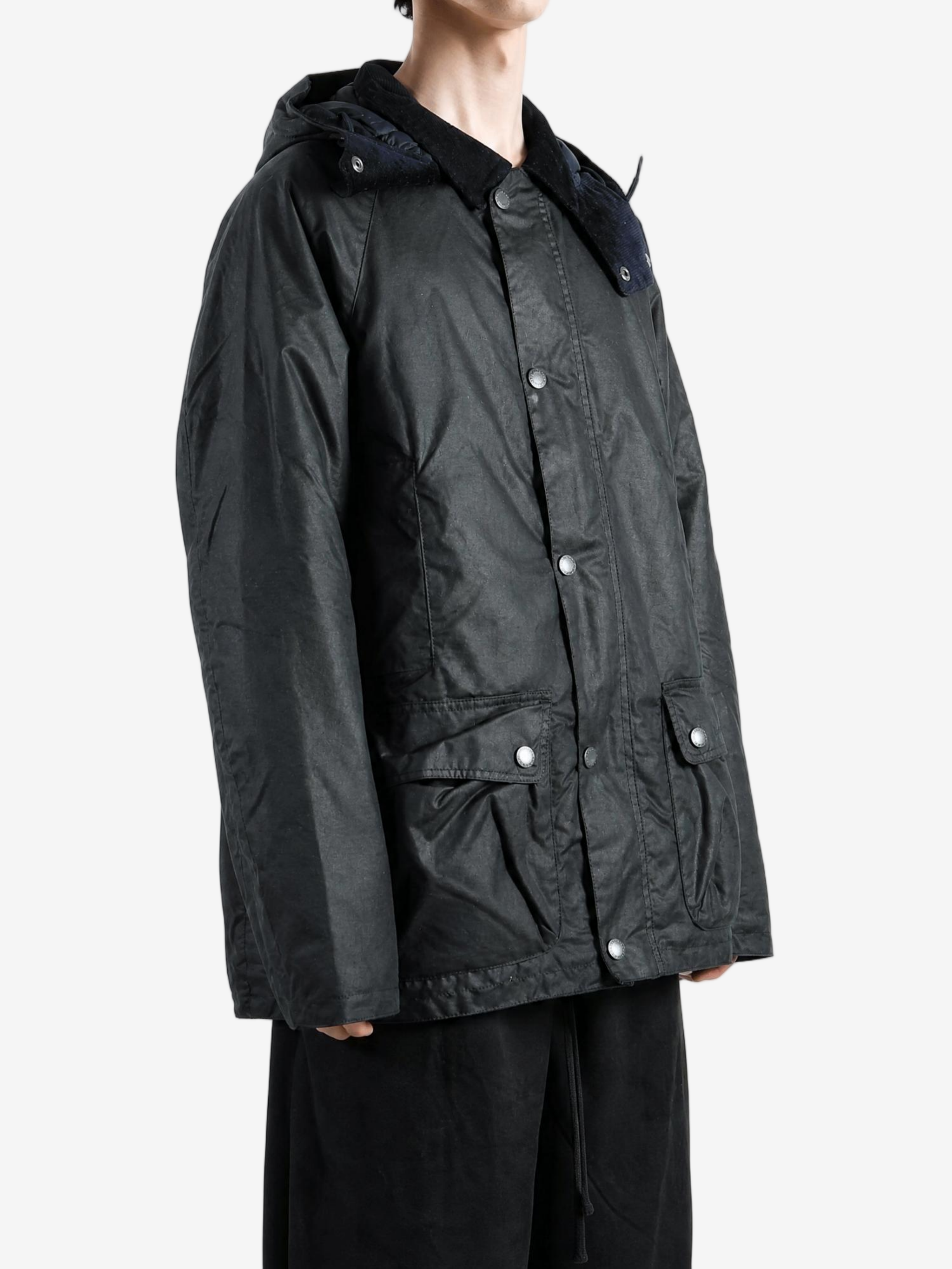 Black jacket worn by a person, showing the jacket fit