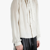 White shirt worn by a person, showing the shirt's fit