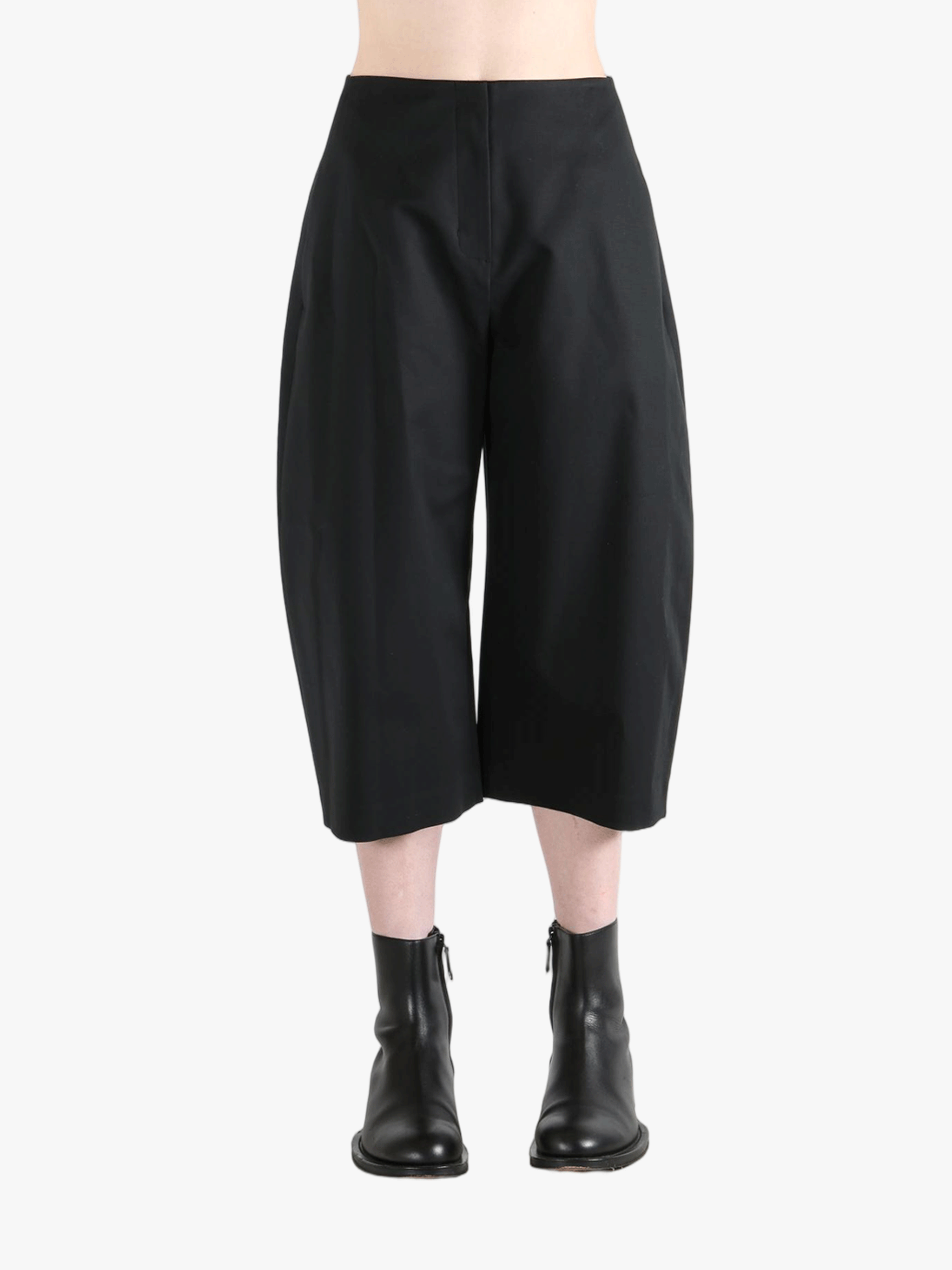 Black pants worn by a person, showing the pants' fit