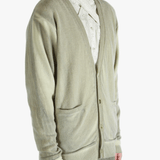 Light green cardigan worn by a person, showing the cardigan fit