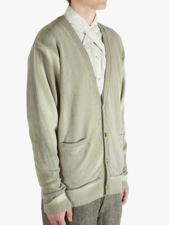 Light green cardigan worn by a person, showing the cardigan fit
