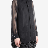 Black shirt worn by a person, showing the shirt fit