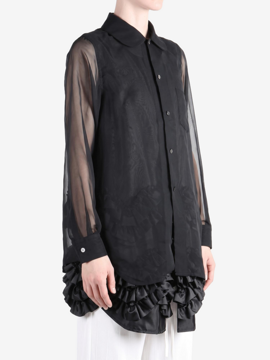 Black shirt worn by a person, showing the shirt fit