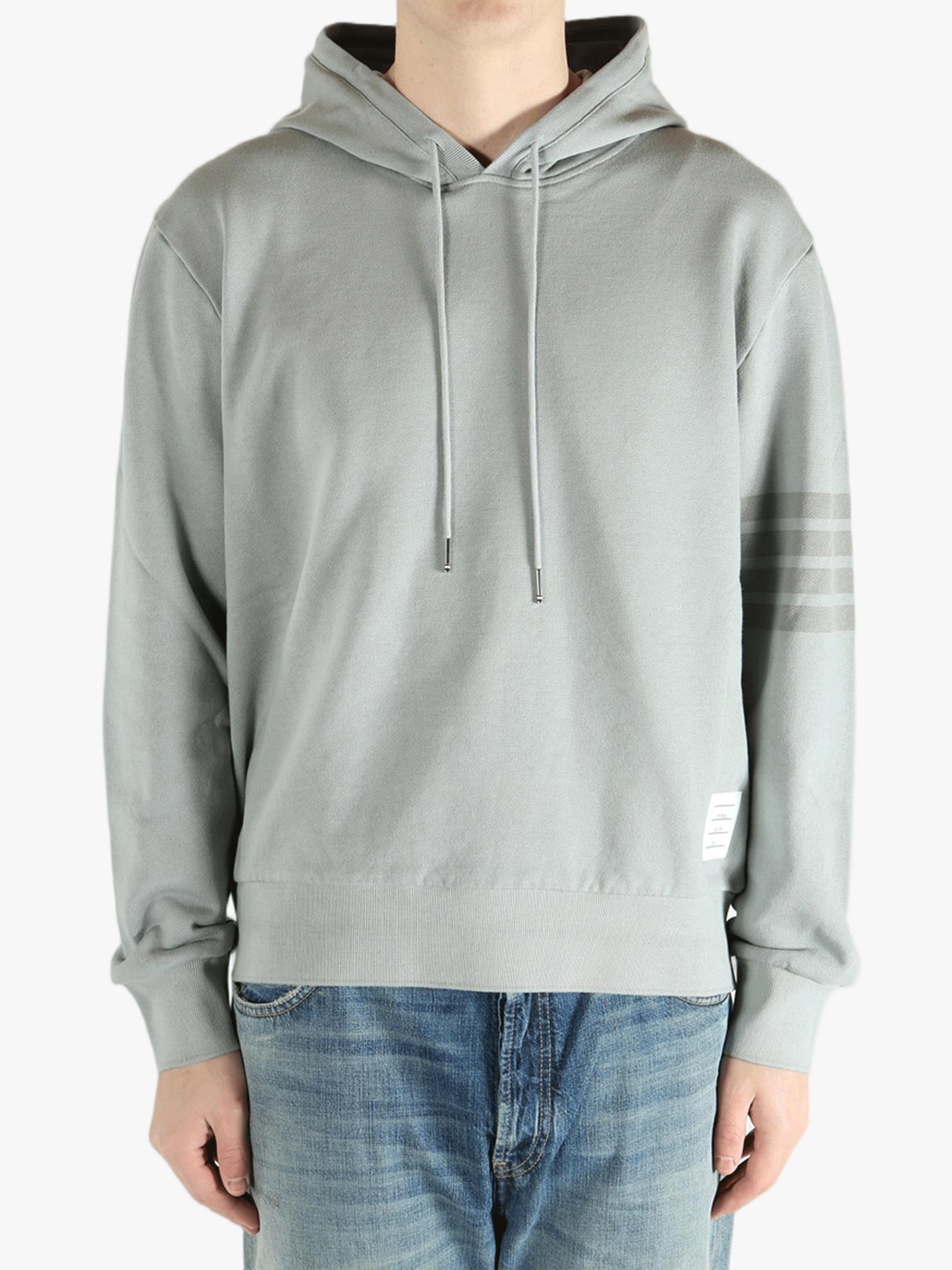 Grey hoodie worn by a person, showing the hoodie fit