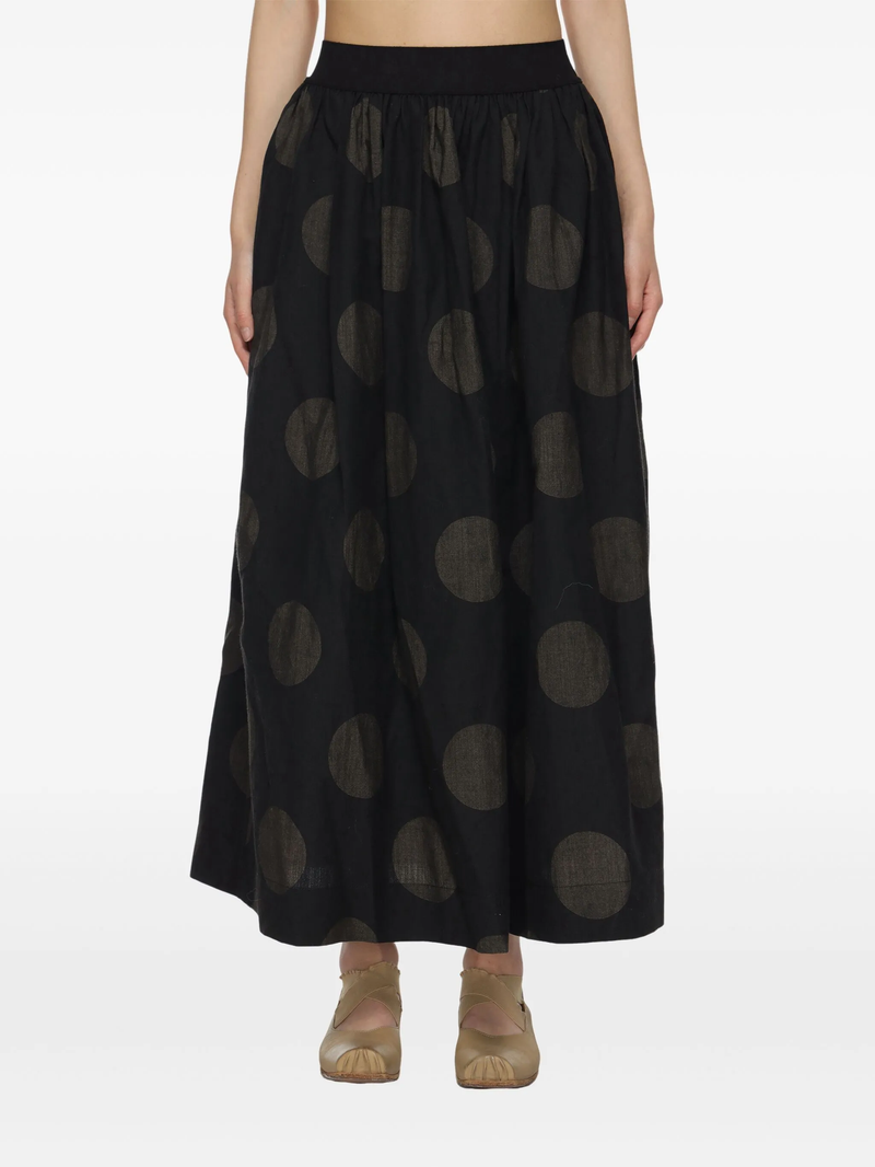 Black midi skirt worn by a person, showing the skirt fit