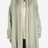 Green cardigan worn by a person, showing the cardigan fit