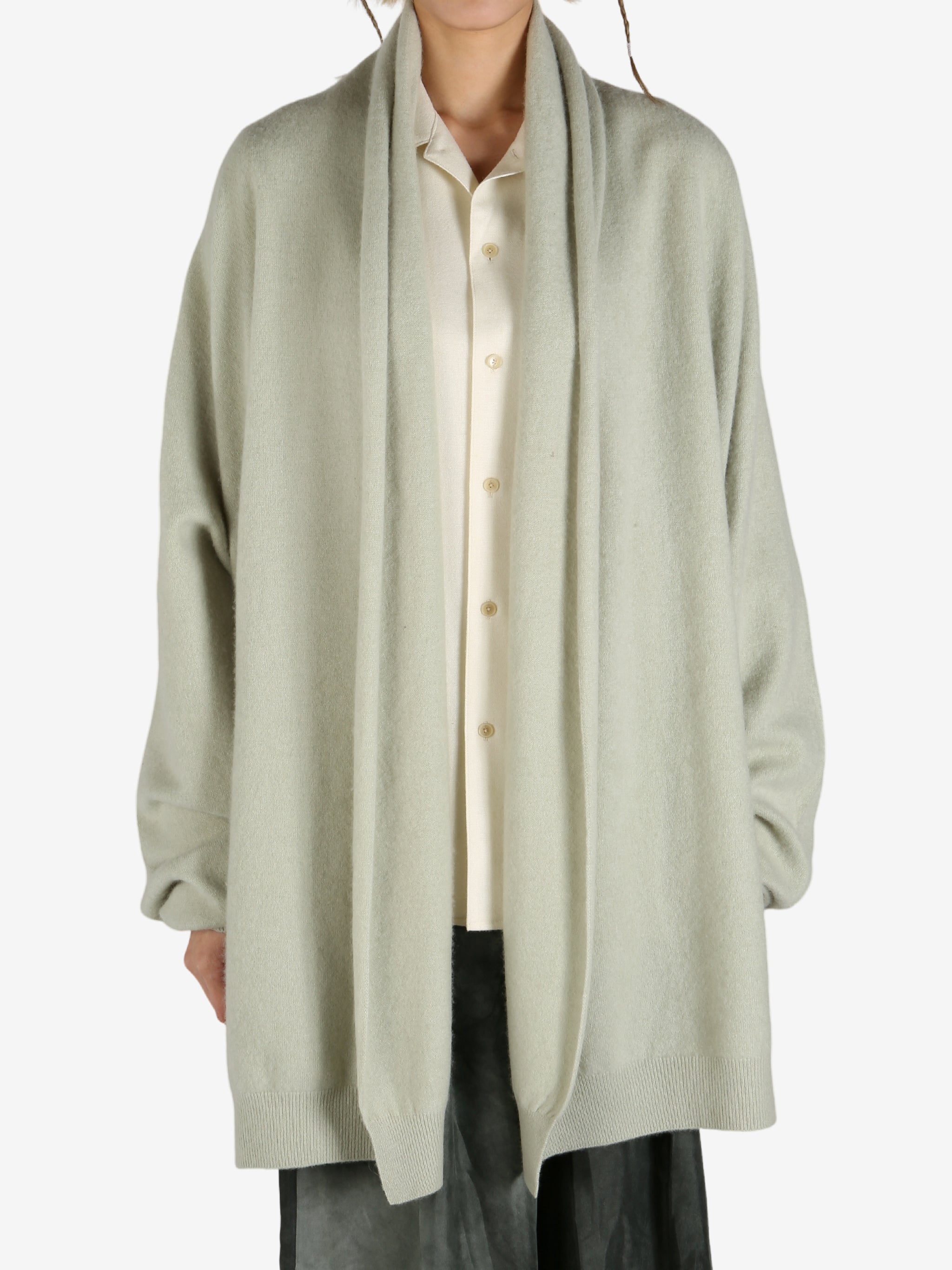 Green cardigan worn by a person, showing the cardigan fit