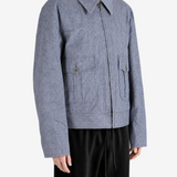 Blue jacket worn by a person, showing the jacket fit