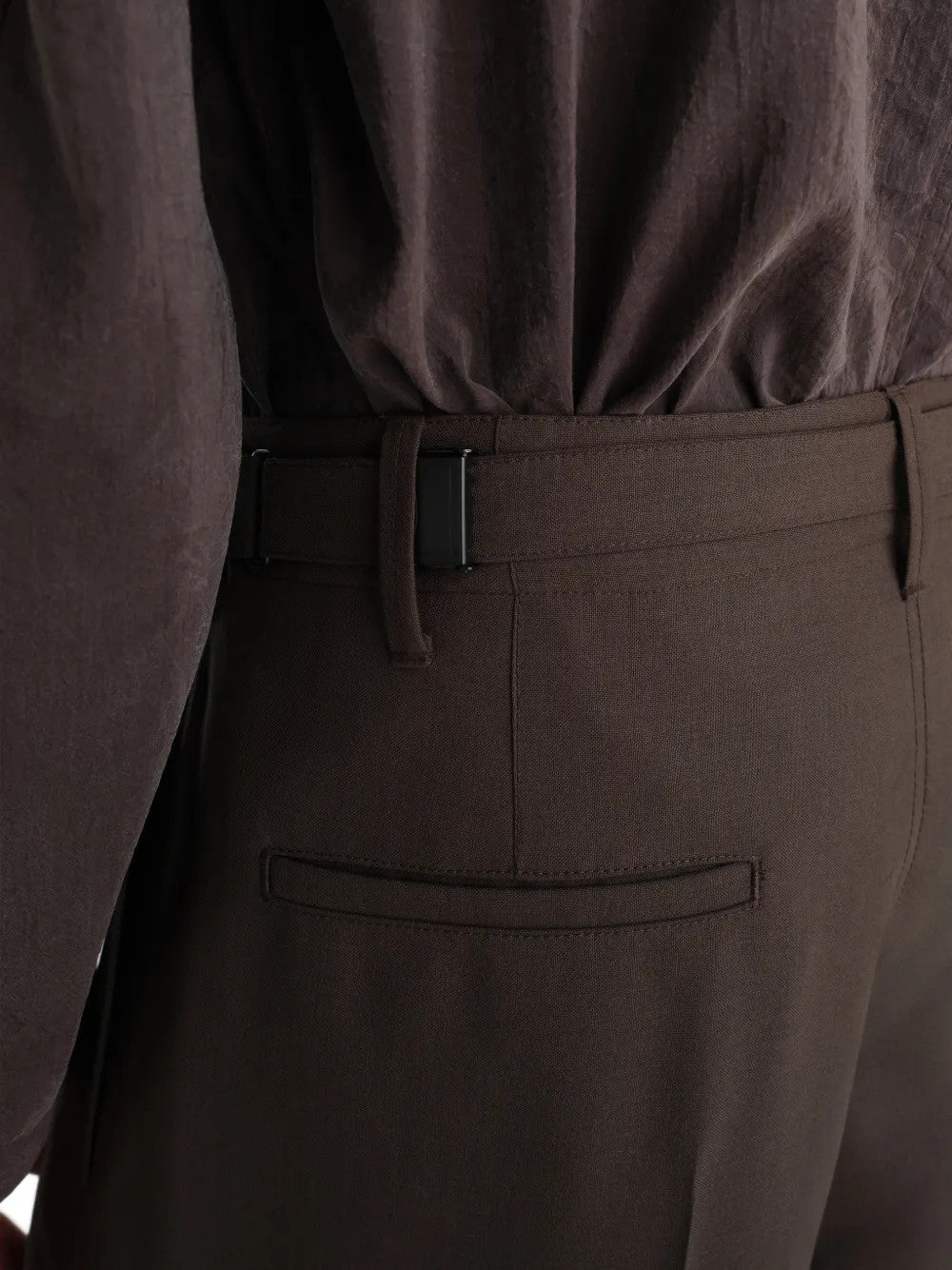 Brown pants worn by a person, showing the pants fit