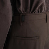 Brown pants worn by a person, showing the pants fit