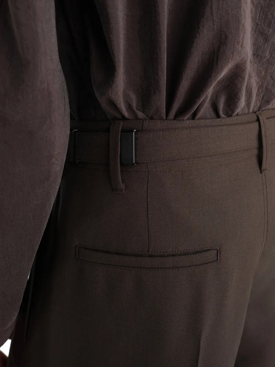 Brown pants worn by a person, showing the pants fit