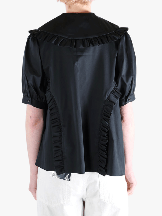 Black t-shirt worn by a person, showing the t-shirt's fit