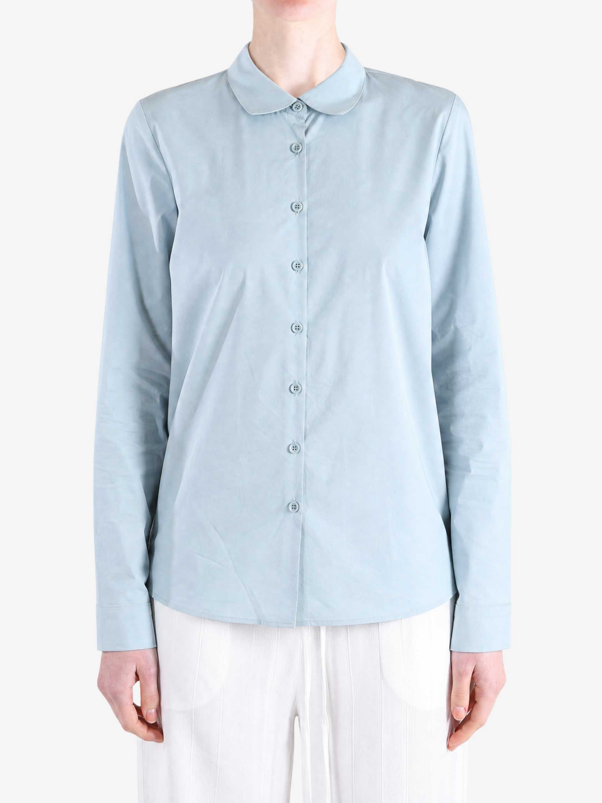 Green shirt worn by a person, showing the shirt fit