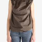 Brown top worn by a person, showing the top fit