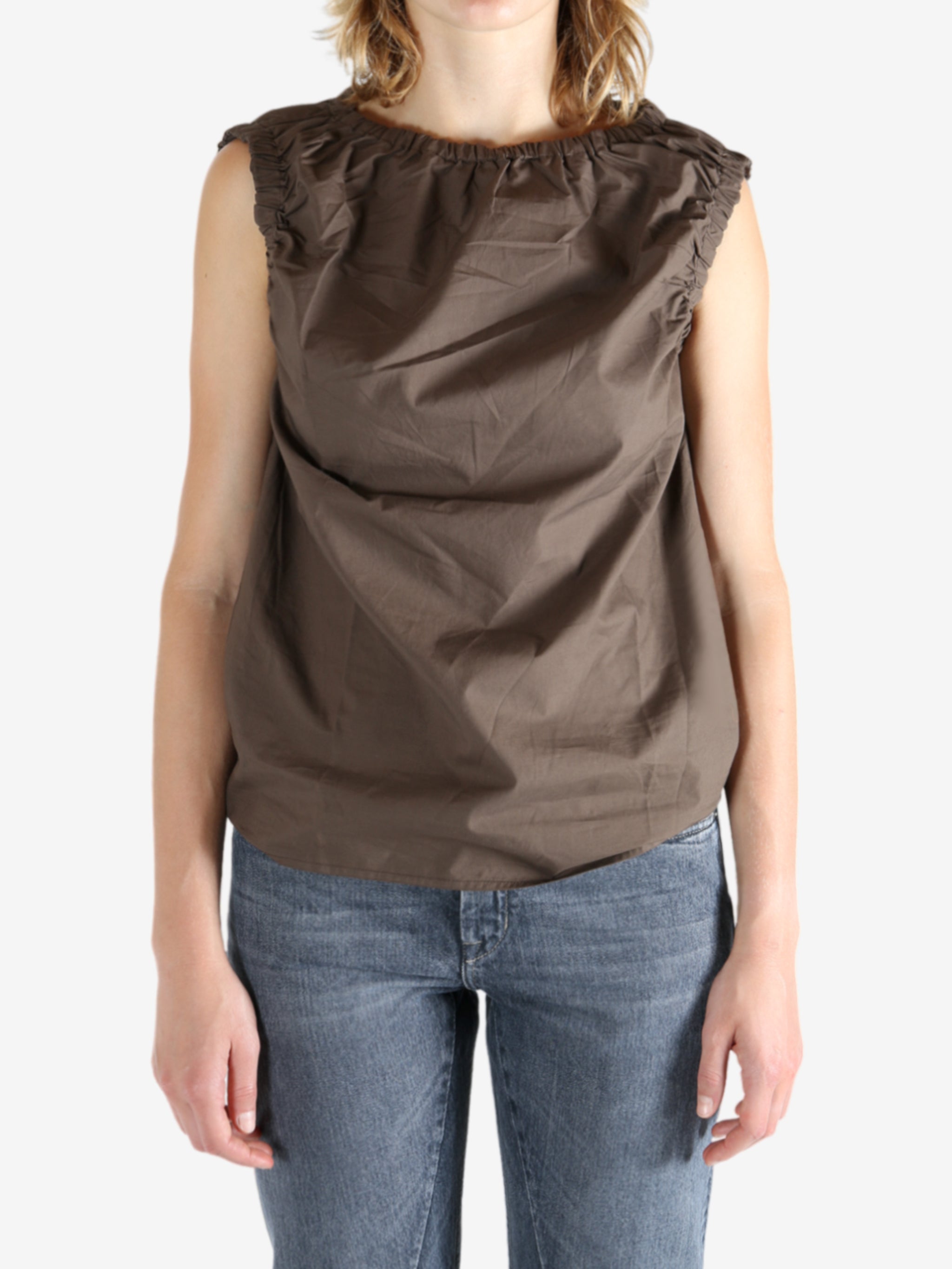 Brown top worn by a person, showing the top fit
