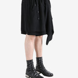 Black shorts worn by a person, showing the shorts's fit