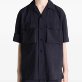 Black shirt worn by a person, showing the shirt's fit