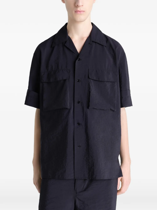 Black shirt worn by a person, showing the shirt's fit