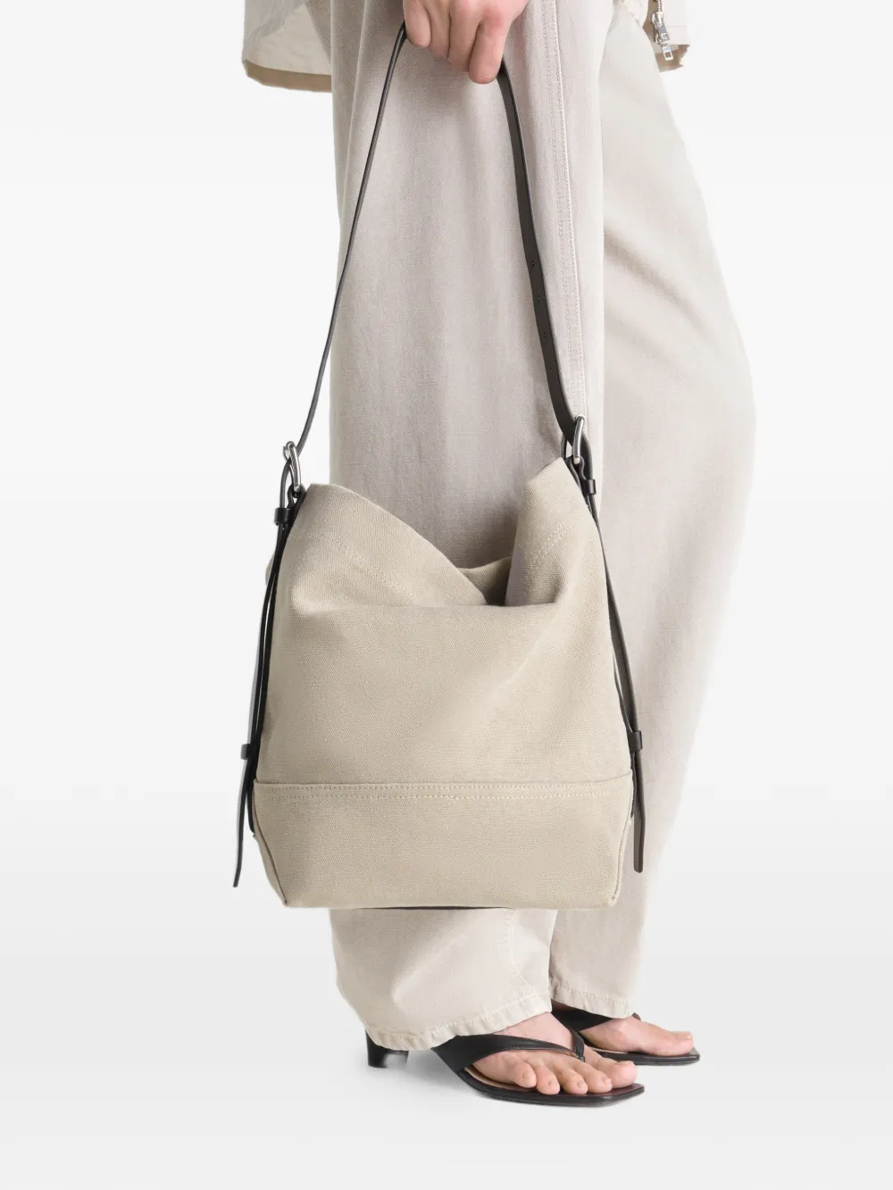 Tan bag worn by a person, showing the bag's fit