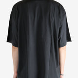 Black shirt worn by a person, showing the shirt's fit