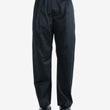 Black pants worn by a person, showing the pants fit