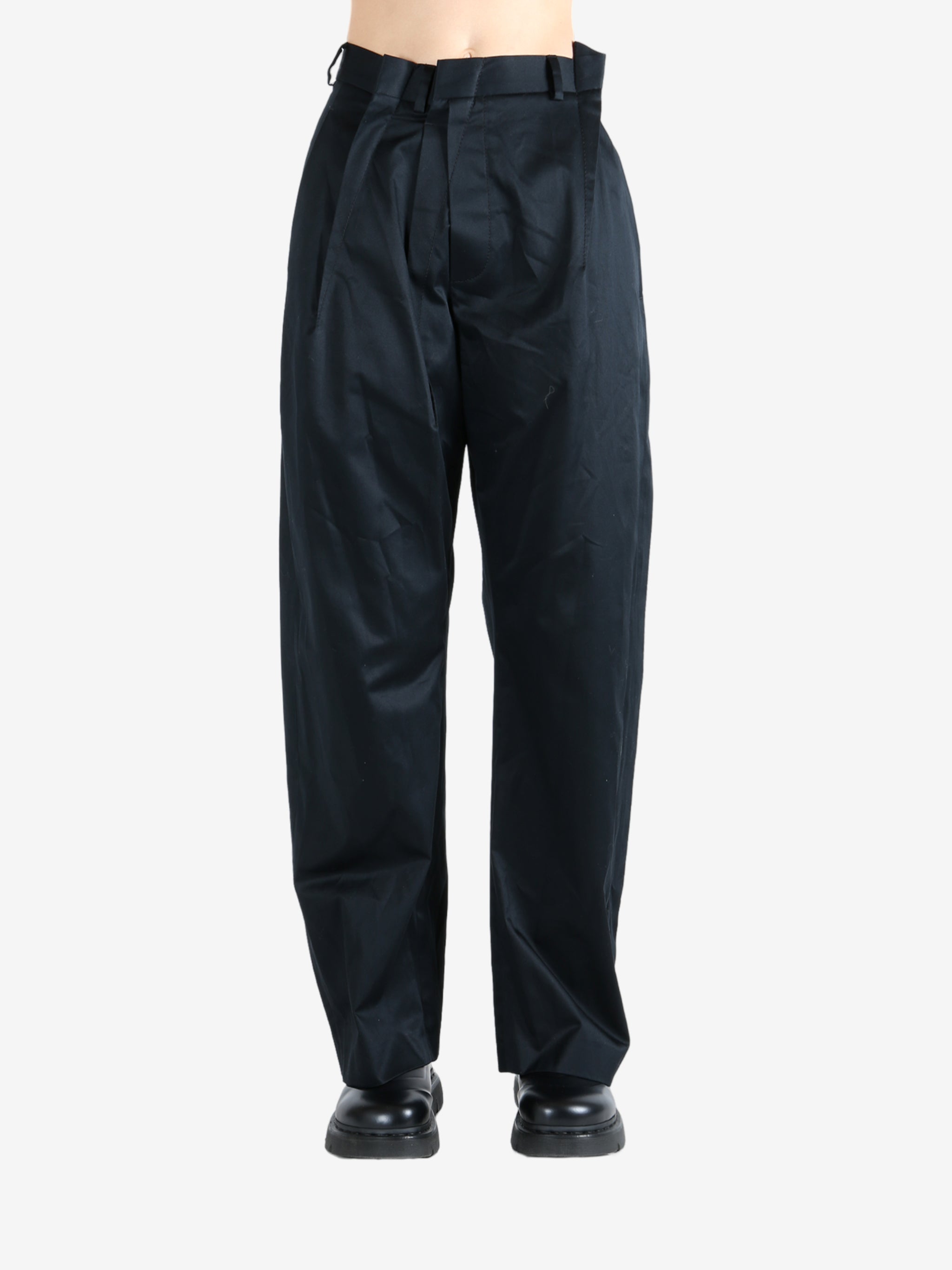 Black pants worn by a person, showing the pants fit