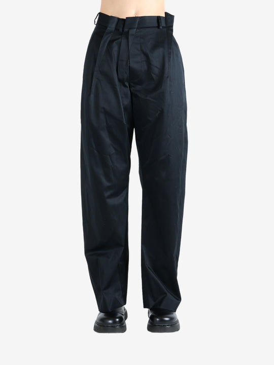 Black pants worn by a person, showing the pants fit