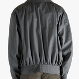 Grey jacket worn by a person, showing the jacket's fit