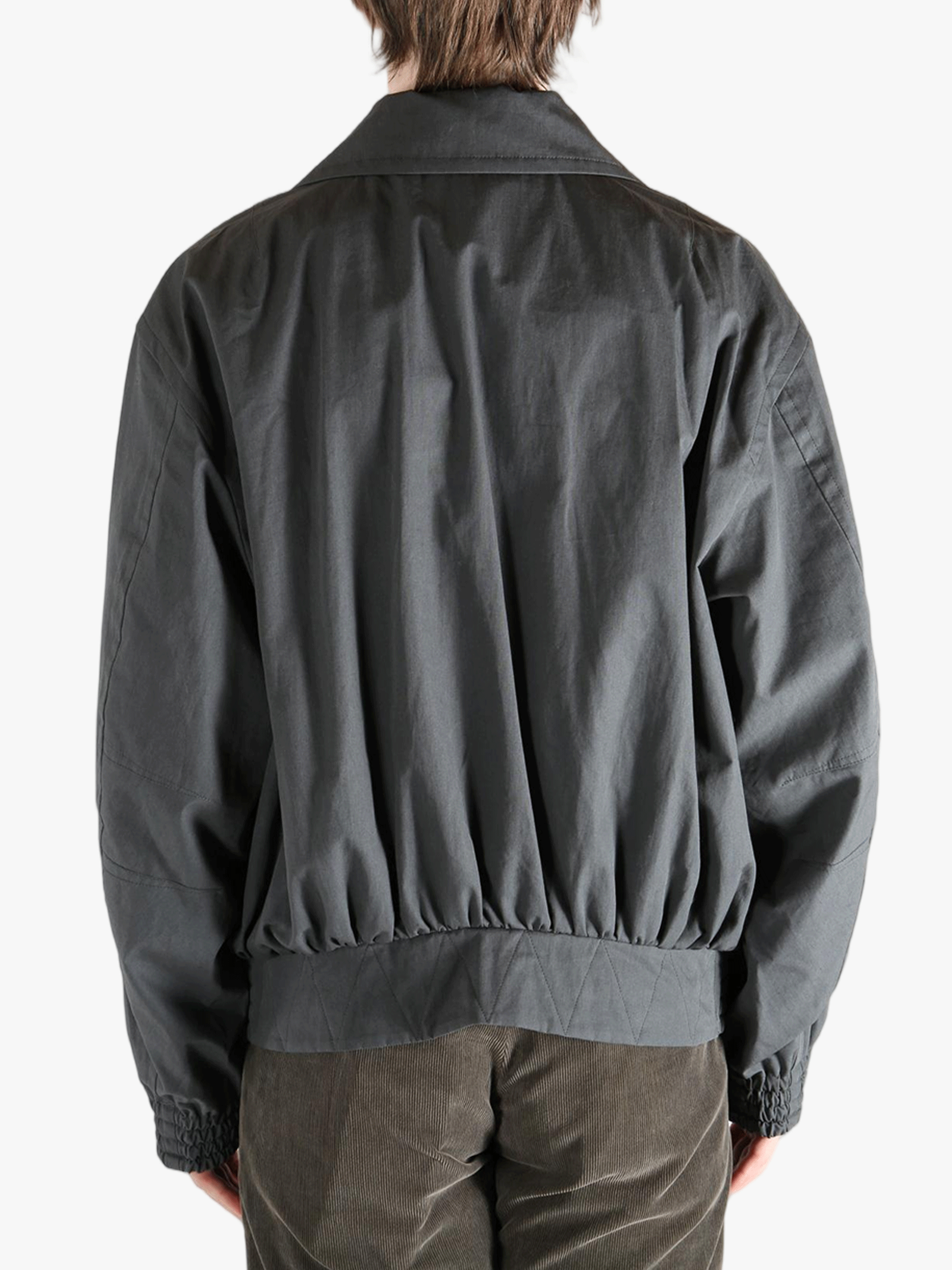 Grey jacket worn by a person, showing the jacket's fit