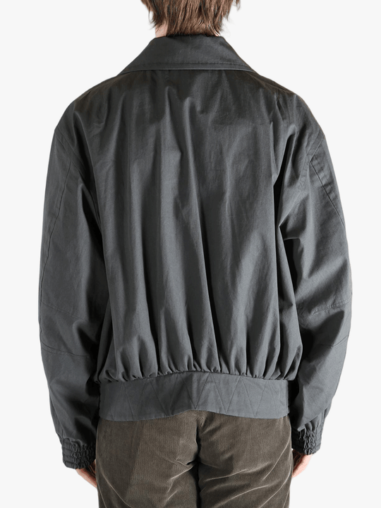Grey jacket worn by a person, showing the jacket's fit