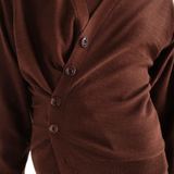Brown knitwear worn by a person, showing the knitwear fit