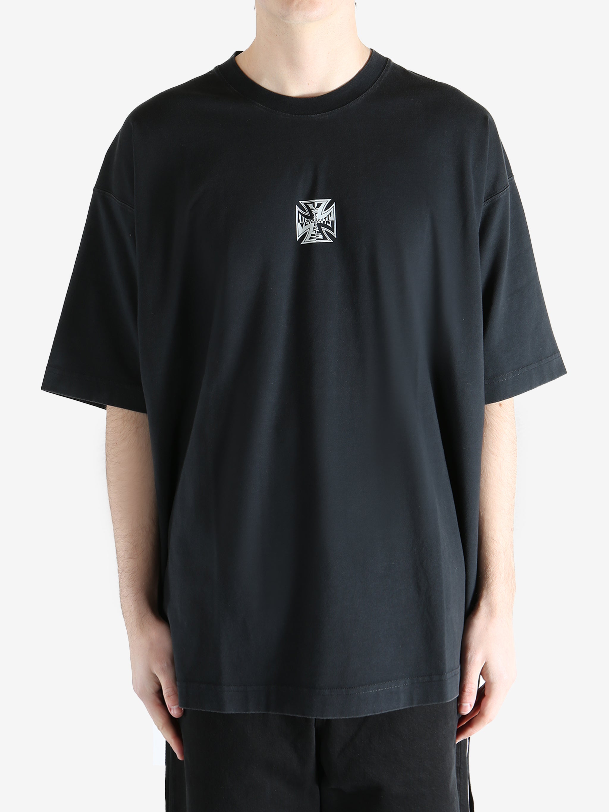 Black t-shirt worn by a person, showing the t-shirt's fit