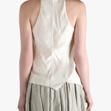 White top worn by a person, showing the top's fit