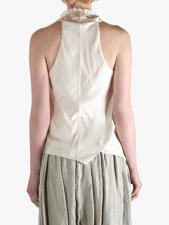 White top worn by a person, showing the top's fit