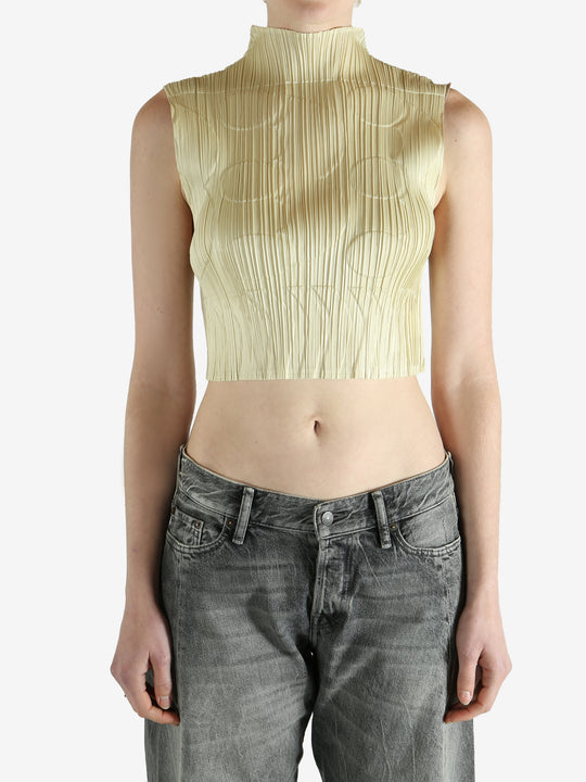 green pleated top worn by a person, showing the top fit