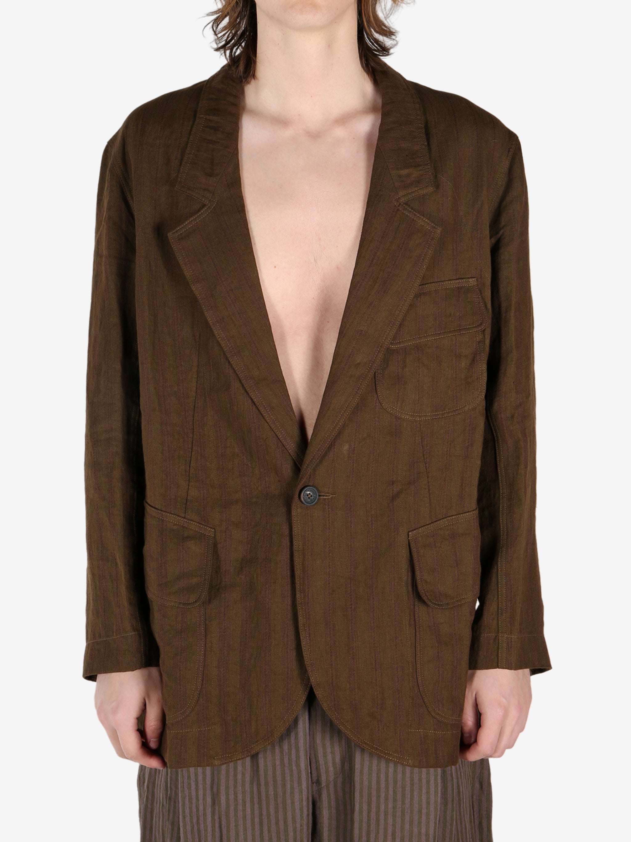 Brown jacket worn by a person, showing the jacket's fit