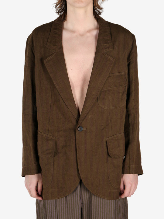 Brown jacket worn by a person, showing the jacket's fit
