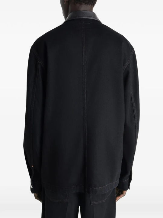 Black jacket worn by a person, showing the jacket's fit